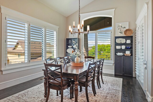 dining room with a chandelier, vaulted ceiling, dark wood-type flooring, and baseboards