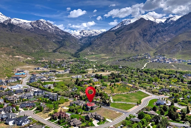aerial view of property's location featuring a mountainous background