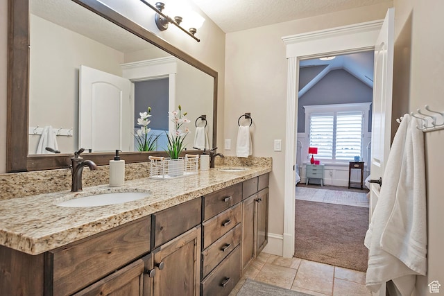 bathroom with double vanity and ensuite bathroom