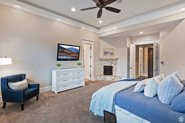 carpeted bedroom featuring crown molding, a fireplace with raised hearth, baseboards, and recessed lighting