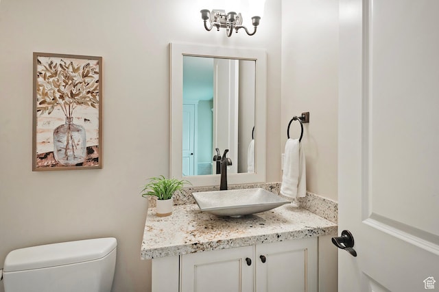 bathroom with toilet and vanity