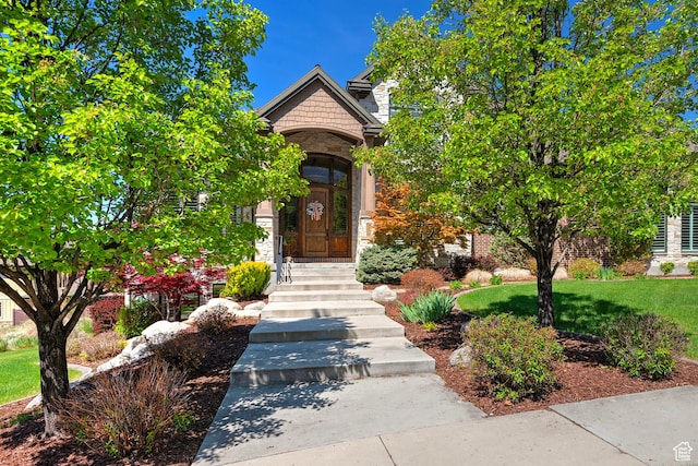 doorway to property with stone siding