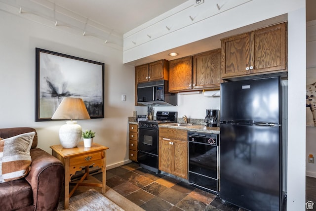 1385 Lowell Ave Unit 101, Park City, UT 84060 - kitchen featuring stone finish flooring, baseboards, brown cabinets, black appliances, and a sink