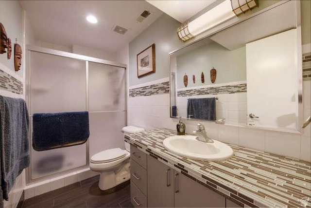1689 E Kierstin Pl, Salt Lake City, UT 84108 - full bathroom featuring vanity, visible vents, a shower stall, tile walls, and toilet