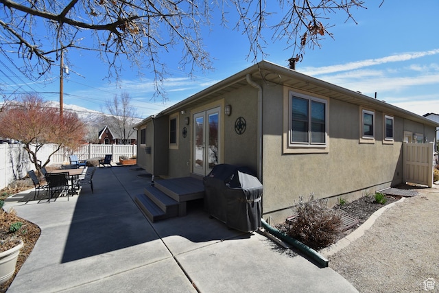 1689 E Kierstin Pl, Salt Lake City, UT 84108 - view of home's exterior featuring a patio, french doors, a fenced backyard, and stucco siding