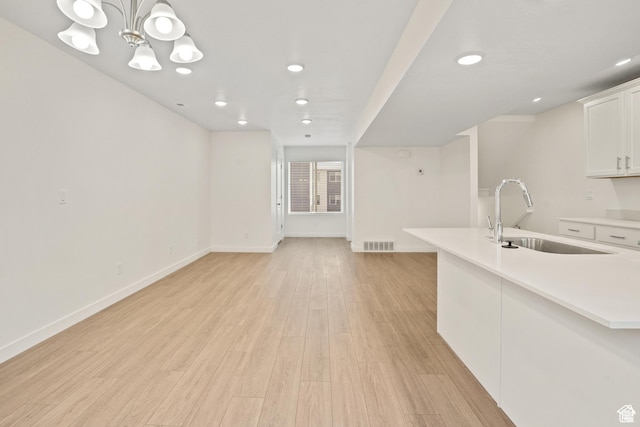 67 E Hamblin Ln, Clearfield, UT 84015 - kitchen featuring a sink, white cabinets, baseboards, light countertops, and recessed lighting