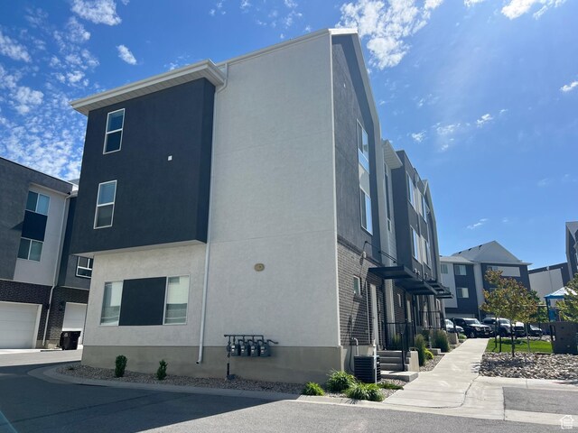67 E Hamblin Ln, Clearfield, UT 84015 - view of side of home featuring stucco siding and a residential view