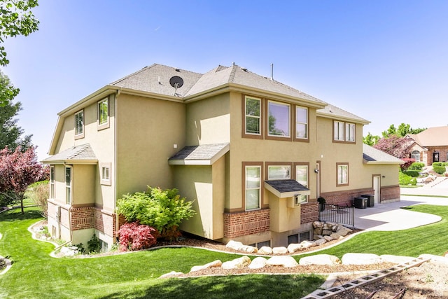 6302 Lone Rock Rd, Highland, UT 84003 - rear view of property with stucco siding, a patio, a yard, and brick siding
