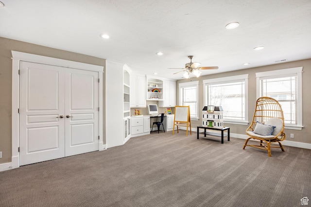 living area with recessed lighting, built in study area, a ceiling fan, baseboards, and carpet flooring