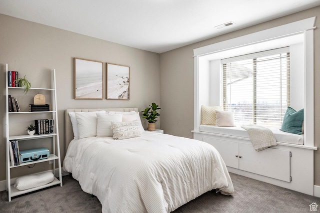 carpeted bedroom featuring visible vents