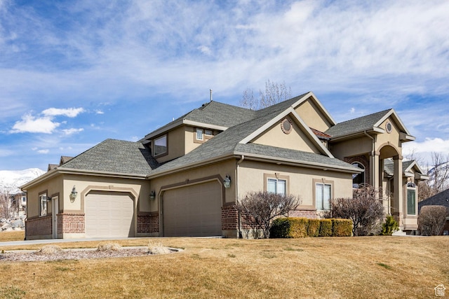 craftsman-style house featuring stucco siding, brick siding, and a garage
