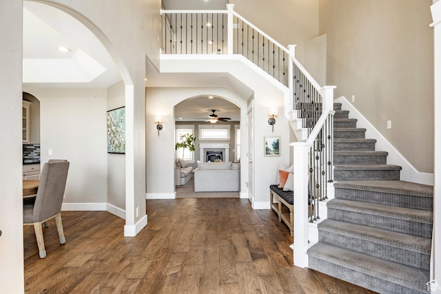 6302 Lone Rock Rd, Highland, UT 84003 - foyer with a ceiling fan, wood finished floors, arched walkways, baseboards, and stairway