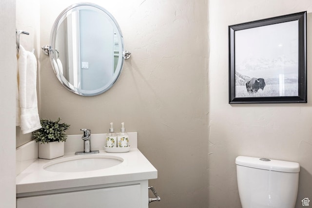 bathroom featuring toilet and vanity