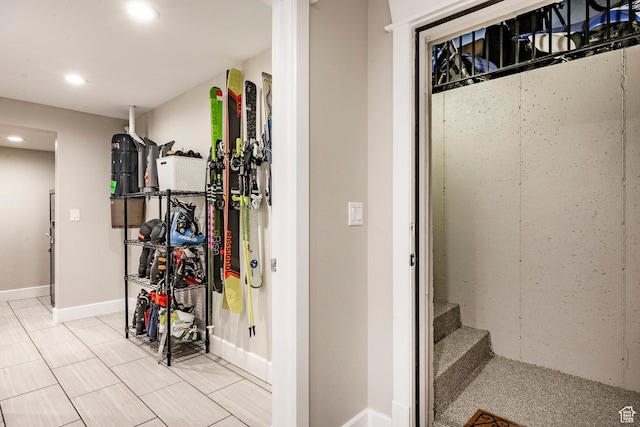 interior space with baseboards, light tile patterned flooring, and recessed lighting