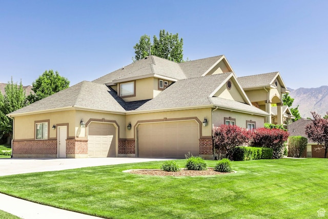 6302 Lone Rock Rd, Highland, UT 84003 - view of front of house with an attached garage, a front yard, stucco siding, driveway, and brick siding
