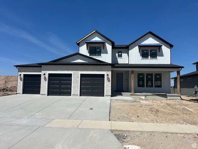 1048 3440 3440 E Unit 121, Spanish Fork, UT 84660 - modern farmhouse style home featuring a garage, a porch, driveway, board and batten siding, and brick siding