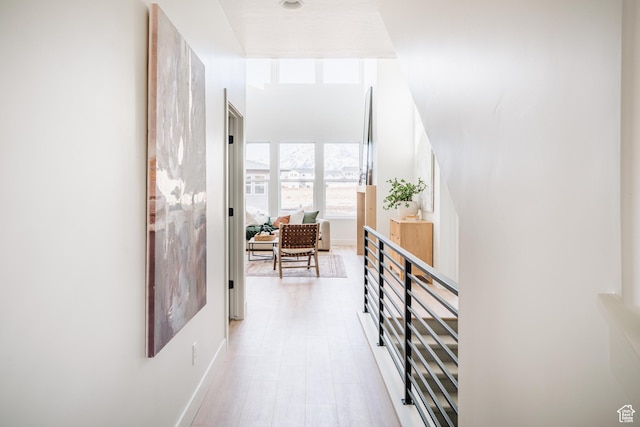 hallway featuring baseboards and wood finished floors
