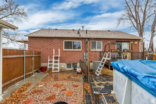 6259 S 340 E, Murray, UT 84107 - back of house with brick siding, a shingled roof, a patio, and fence