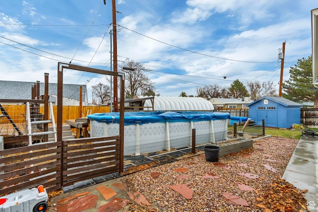 6259 S 340 E, Murray, UT 84107 - view of swimming pool featuring a fenced in pool, an outdoor structure, a fenced backyard, and a shed