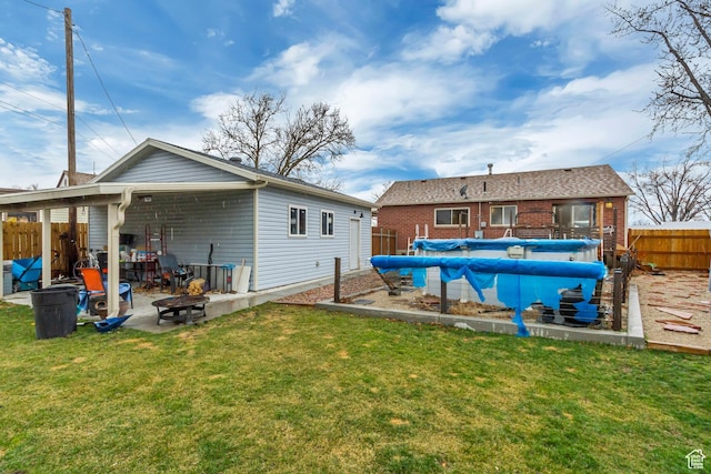 6259 S 340 E, Murray, UT 84107 - rear view of house with a fenced in pool, fence, an outdoor fire pit, a yard, and a patio area