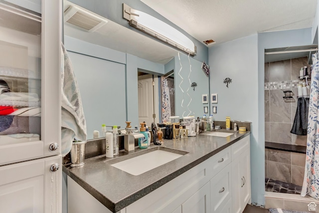 6259 S 340 E, Murray, UT 84107 - full bathroom featuring double vanity, visible vents, tiled shower, and a sink