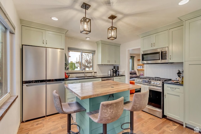 6259 S 340 E, Murray, UT 84107 - kitchen with decorative light fixtures, butcher block countertops, appliances with stainless steel finishes, light wood-style floors, and a sink