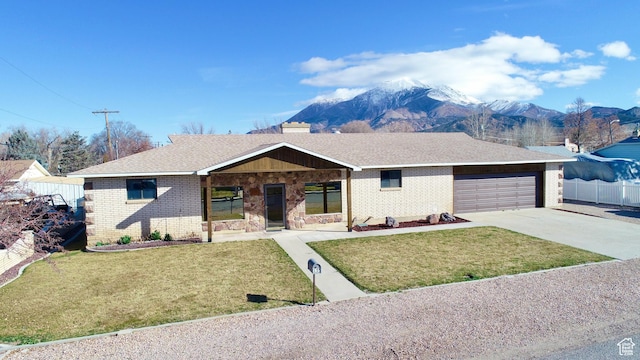 ranch-style home with driveway, brick siding, a front yard, and fence