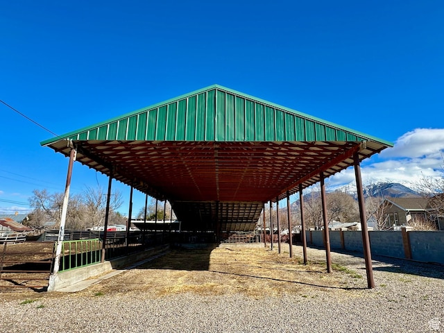 view of property's community featuring an exterior structure, a carport, and an outdoor structure