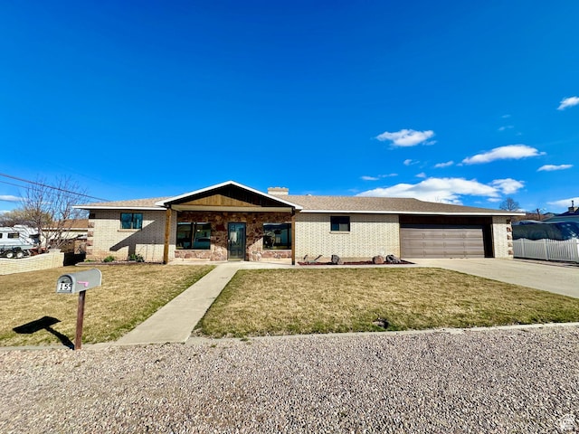 view of front of home featuring brick siding, a front lawn, fence, concrete driveway, and an attached garage