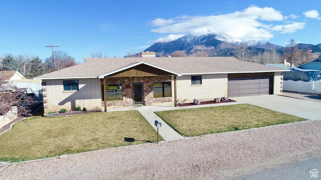 ranch-style home with brick siding, concrete driveway, and a front lawn