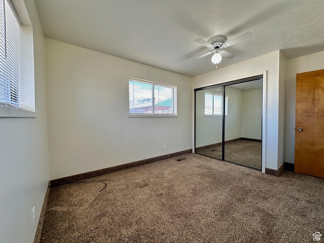 unfurnished bedroom featuring a closet, baseboards, and carpet flooring