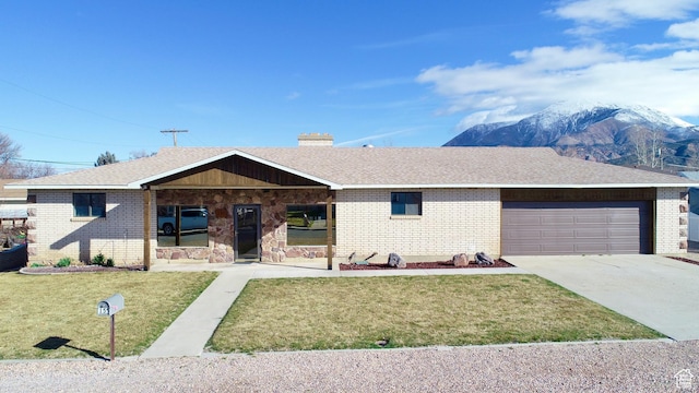 ranch-style home featuring driveway, an attached garage, a chimney, a front lawn, and brick siding