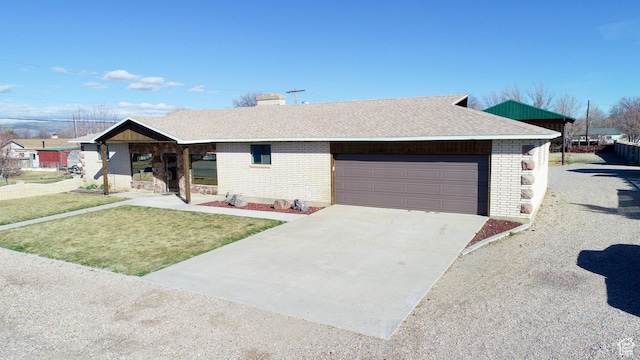 ranch-style house featuring brick siding, a front lawn, concrete driveway, and a garage