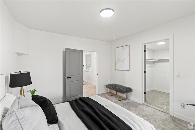 555 N 100 W, Tooele, UT 84074 - bedroom with a walk in closet, baseboards, and light colored carpet