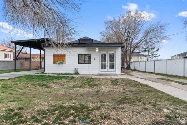 555 N 100 W, Tooele, UT 84074 - view of front of property with a front lawn, french doors, fence, and driveway