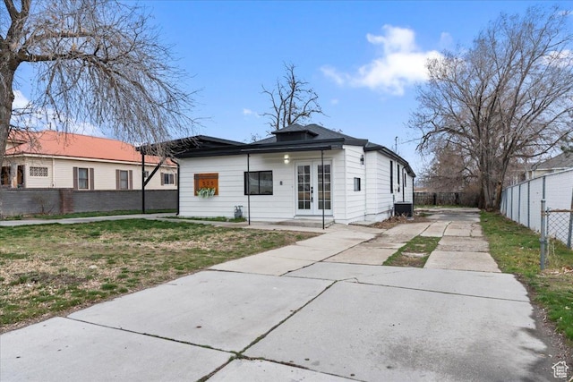 555 N 100 W, Tooele, UT 84074 - rear view of property with central AC unit, french doors, concrete driveway, and fence