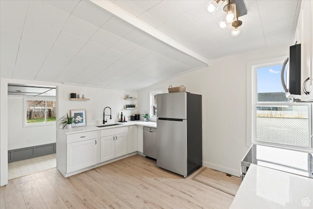 555 N 100 W, Tooele, UT 84074 - kitchen featuring a sink, open shelves, appliances with stainless steel finishes, light countertops, and vaulted ceiling