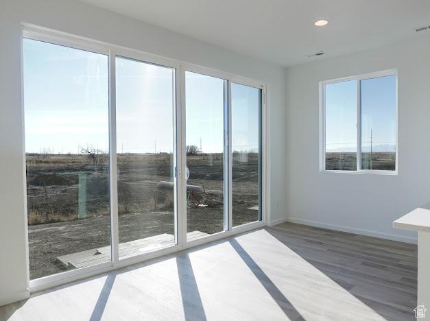 1114 W 450 S Unit 62, Brigham City, UT 84302 - empty room with plenty of natural light, wood finished floors, recessed lighting, and baseboards