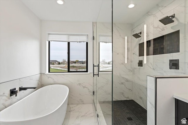 full bathroom with a soaking tub, recessed lighting, marble finish floor, and a marble finish shower