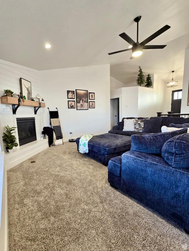 9480 N 5600 W, Elwood, UT 84337 - living room with a fireplace, carpet flooring, ceiling fan with notable chandelier, and vaulted ceiling