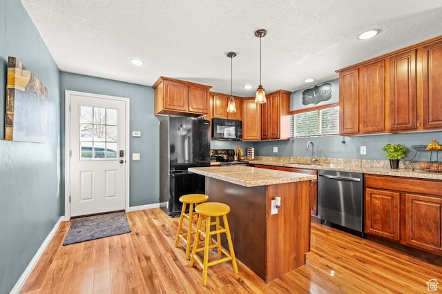 1065 E 900 S, Pleasant Grove, UT 84062 - kitchen with a sink, black appliances, a center island, and light wood finished floors