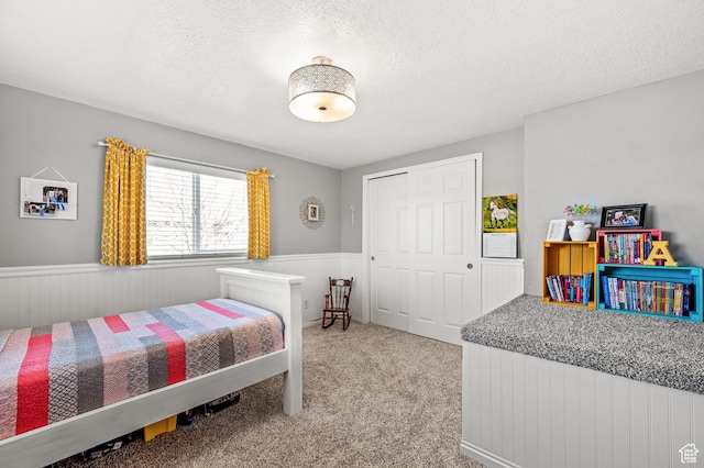 1065 E 900 S, Pleasant Grove, UT 84062 - bedroom featuring a closet, a wainscoted wall, carpet flooring, and a textured ceiling