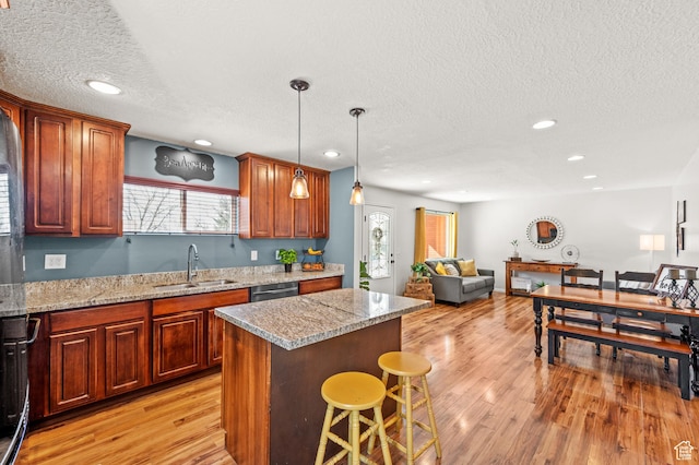 1065 E 900 S, Pleasant Grove, UT 84062 - kitchen with a sink, a kitchen island, a breakfast bar, and light wood-style flooring
