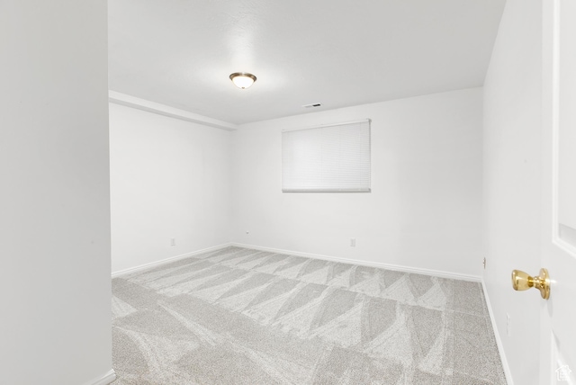 carpeted empty room with visible vents and baseboards