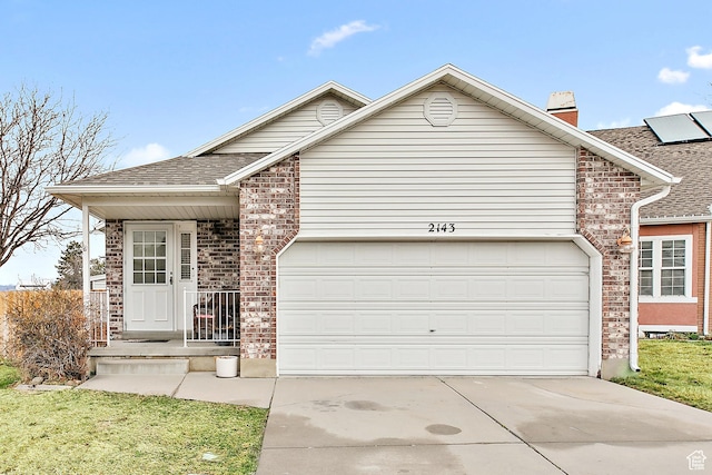 ranch-style house featuring an attached garage, brick siding, driveway, and a chimney