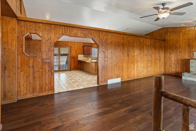 3356 W 1200 S, Ogden, UT 84404 - unfurnished room featuring arched walkways, hardwood / wood-style flooring, vaulted ceiling, a ceiling fan, and wooden walls