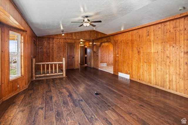 3356 W 1200 S, Ogden, UT 84404 - unfurnished living room featuring ceiling fan, lofted ceiling, wood-type flooring, and wooden walls
