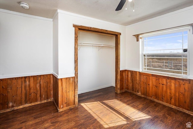 3356 W 1200 S, Ogden, UT 84404 - unfurnished bedroom featuring wood finished floors, a closet, wood walls, and wainscoting