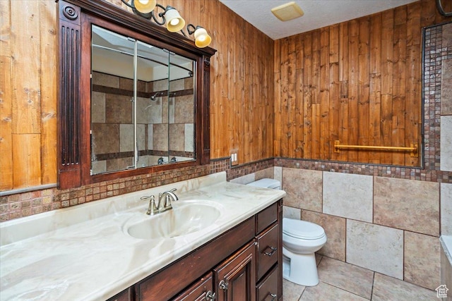 3356 W 1200 S, Ogden, UT 84404 - bathroom with tile patterned flooring, wood walls, toilet, vanity, and tile walls