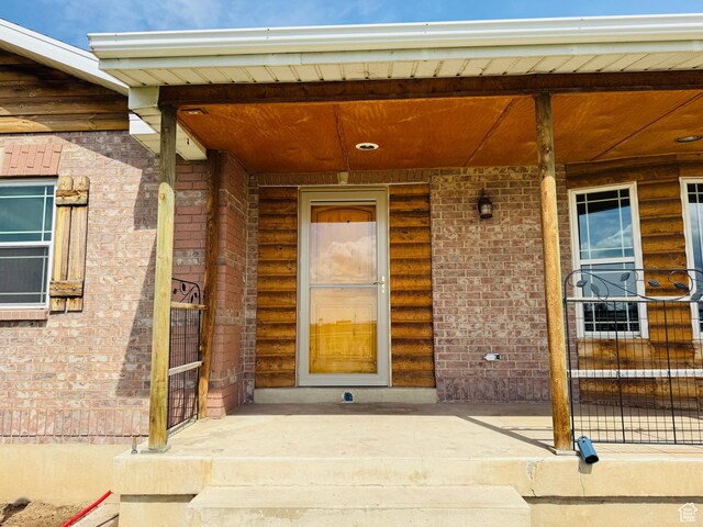 3356 W 1200 S, Ogden, UT 84404 - property entrance featuring brick siding and a porch